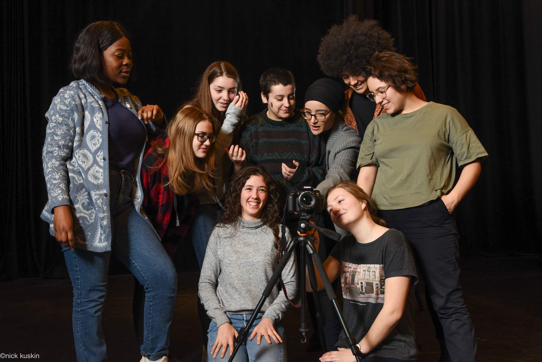 young women behind camera